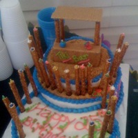 Tropical Cake I hollowed out pretzel rods to fit the candles down in. Tiki hut is made with the rods and graham crackers.