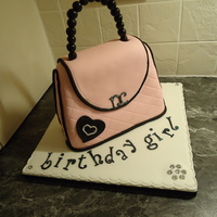 Chanel Style Handbag Cake chocolate mud cake, iced with pink quilted fondant. The beaded handle is made of fondant - diamante heart set into black fondant heart