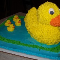 Duck Cake I used an 11x14 sheet cake with a 3-D duck cake on top. The little ducks are cupcake picks with icing piped on them.