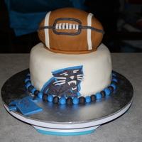 Carolina Panther's Cake 2 layer 8" topped with a 2 layer 6" carved into the shape of a football.