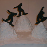 Snowboarder snowboard cake,mountains are rice krispy treats,snowboarders are fondant