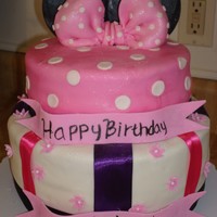 Minnie Mouse Cake This cake was done for a two year old's birthday party. I was working on a limited budget so instead of using all fondant accents I...