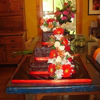 Chocolate Ganache Wedding Cake With Fresh Flowers This was my first wedding cake and first ganache cake. I made this as a gift for a dear friend of mine who was finally marrying her long...
