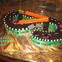Race Track This was for my son's 5th birthday. I uesd 2 wilton horseshoe pans for the track. This cake was a huge hit.