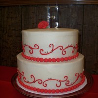 Simple Red Scroll Wedding Cake Simple round tiered wedding cake. It was accompanied by 300 cupcakes! Cake is red velvet w/ vanilla buttercream filling.