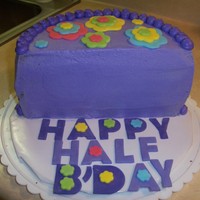 Half Birthday Purple buttercream and fondant fun flowers for a little girl's half birthday.