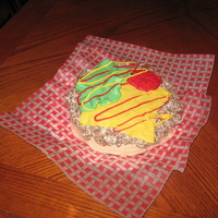 Hamburger Birthday Cake Bun is white cake, patty is chocolate rkt, condiments are icing and mmf.