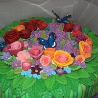 Flower Bouquet Cake Took 3 days to put this together. Marshmallow fondant flowers and stems, royals icing butterflies. The ribbon is real.