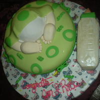 Baby Shower Cake Bottom layer is Chocolate Fudge with BC and Fondant accents. "Diaper" is Cherry Vanilla. Legs and feet are gumpaste. Fondant...