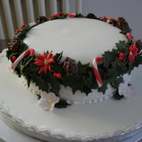 Holly Wreath On Top Of Fruit Cake With Marzipan And Sugarpaste Christmas cake with holly, berries, christmas roses and candy canes