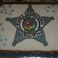 Police Star Made for work christmas party. Chocolate& Yellow layer with aprioct/peach filling. Buttercream star, rice paper snowflakes.