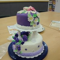 Purple Tiered Cake My first tiered cake. Devil's food cake with orange filling, bottom layer is BC with fondant flowers top layer is fondant covered with...