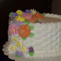 Flowered Mother's Day Cake First time I attempted basketweave: it's a marble cake with buttercream icing, flowers are buttercream and RI