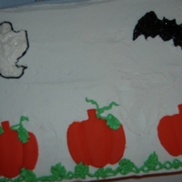 Pumpkin Cake dark chocolate cake with rasberry filling. Pumpkins are fondant, ghost and bat are bc.