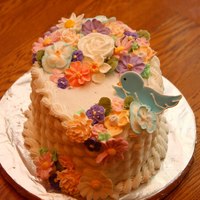 Flower Basket Covered in BC icing with Royal Icing flowers and bird