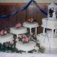 Heart Shaped Wedding Cake With Fresh Pink Roses This is a cake I made for a friend's wedding. My 3rd wedding cake. Heart shaped tiered cake with four heart shaped satellites,...