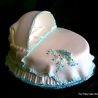 Baby Bassinett The cake is covered with buttercream. Hood is made of sugarpaste several days in advance. Pillow is fashioned from buttercream and covered...