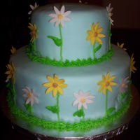 Daisy Cake Blue fondant, Daisies are made of fondant with gum tex, stems and grass are green buttercream frosting.