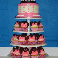 My First Minnie Mouse Cake And Cupcake Tower This is my first time making a cupcake tower! 8 in buttercream minnie mouse cake with a half ball pan for minnie hat and fondant ears on...