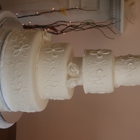 Simple White This is a cake dummy I made for a bridal show last weekend. Covered it fondant with piped royal icing and my first gumpaste roses. Tiers...