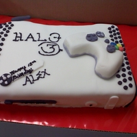 X-Box 360 chocolate fudge cake covered in fondant. I tried to get all the details of what a real one looked like. The remote was made with cereal...