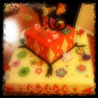 Sweet 16 Yellow Cake with Chocolate frosting layer and Duff's Buttercream Fondant.Flowers are gumpaste.