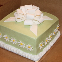 Daisy Bow Cake 8" Square cake with buttercream frosting- A fondant/gumpaste bow and daisies. Moss gel coloring for the buttercream.
