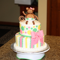 Natasha's Baby Shower Cake Layers are 9" and 6" frosted in buttercream and decorated with fondant accents. The monkey is fondant covered Rice Krispie treats...