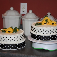 Polka Dots And Sunflowers 2 9" Round cakes with buttercream frosting. I used ribbon backed with clear sticky plastic around the bottom and adhered to itself...