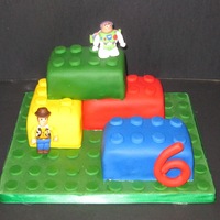 Lego Cake This is made for my friends' son. He loves legos and wanted wood and buzz lego guys. The lego men are made from fondant.