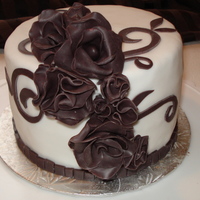 Purple Roses & Flowers purple modelling chocolate roses & fantasy flowers on white fondant.