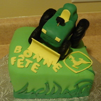 John Deere Tractor RKT tractor on butterscotch cake made to resemble terrain of the birthday man's property. Made the tractor so it could actually be...