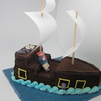 Pirate Ship Cake i just made this for the fun of it.. took me around 3 hours only.. cake is covered with butter cream. pirate, cannons and anchore are...