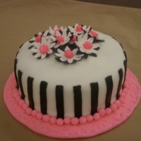 Class Cake This is a cake I completed in class.Fondant over BC.Gumpaste daisy,MMF stripes and boarder.Lemon pound cake.