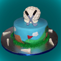 Golf Coconut cake with coconut buttercream. Golf ball, tees and clubs are made with modeling chocolate.