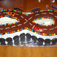 Race Car Cake I made this for my son's 7th birthday. I used 2 horse shoe pans then I cut another cake to fit the center. The kids loved it.