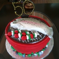 Big 50Th Birthday 3 12" layers of vanilla cake, covered in buttercream and fondant and filled with a strawberry/raspberry mousse. The fish is carved...