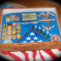 Navy Retirement Shadow Box Cake Cake covered in fondant, Medals, ribbons, pins, and other decorations done in gum paste. Caduceus made from royal icing.