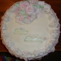 Rose Birthday Cake For my mom's birthday. Learned a lot on this, just sort of flew by the strings of my apron. Chocolate cake with carmel pecan filling...