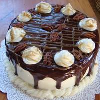 Ganache Covered Chocolate cake with pecan carmel filling. Covering in buttercream and ganache.