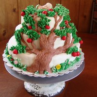 Baby In The Boughs Of An Apple Family Tree For Jacob. Fondant covered three layer cake. Tree trunk is modeling chocolate, leaves and grass buttercream, gum paste baby, apples and...