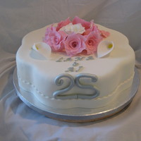 Silver Anniversary I made this for a friend's daughter. Chocolate with vanilla kahlua filling. Fondant decorations. TFL!!