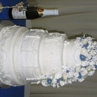 White & Blue Wedding Cake - July White fondant, gumpaste flowers, 4 layer-multi flavor cake and fillings -