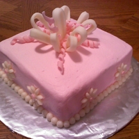 Bridal Luncheon Cake This cake was for a bridal luncheon. The bride wanted white cake iced in pink buttercream with a fondant bow and fondant daisies.