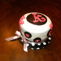 Katy's Surprise Cake Fondant covered butter cake with fondant monogram and flower cut outs.