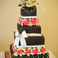 Black Wedding Cake With Gum Paste Flowers From the bottom up: Cream Cheese pound cake with amaretto cream, chocolate blackout cake with espresso truffle filling and chambord syrup,...