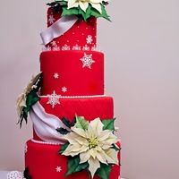 Holiday Cake Cake I made for a local competition. You might recognize the ivory gum paste poinsettias that I posted a week or so ago... :) Red satin ice...