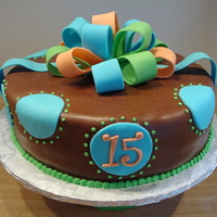 Birthday Cake WASC cake with chocolate MMF. Bow in gumpaste/fondant blend, blue dots fondant and green dots buttercream. This was my first time using...