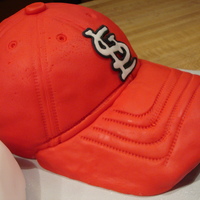 Cardinals Hat Half sports ball cake and 6"round covered in MMF. My gumpaste bill faded really bad so I used the bill of a real hat and covered it in...