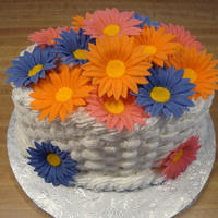 Daisy Basket Oval cake with buttercream basket weave and fondant daisies.